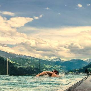 Man swimming in the infinity sky pool at Mia Alpina
